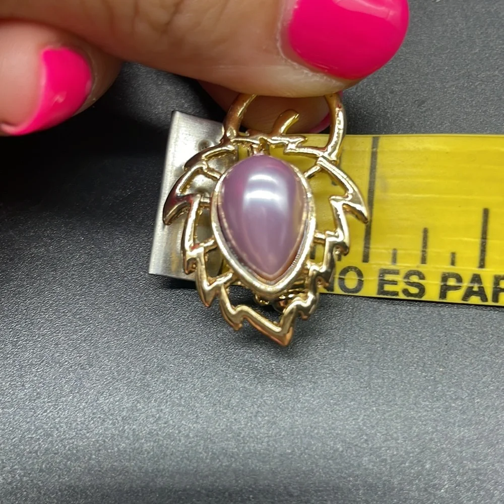 Gold plated brooch with a stone in the center | the stone color is a lavender